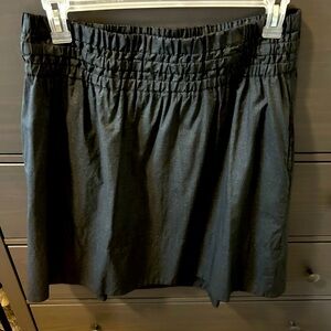 Nice, soft but firm semi shiny grey fabric skirt. Fully lined.